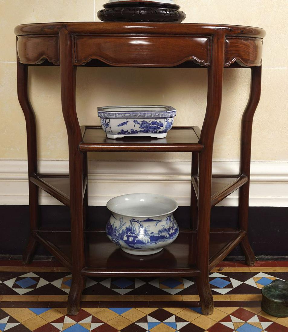 PAIR CHINESE HARDWOOD CONSOLE TABLES: each with a marble inset demi-lune shaped top above a conforming serpentine frieze over a series of shelves, raised on naturalistic scroll legs. 83 cm. high; 83 cm. wide; 42 cm. deep
