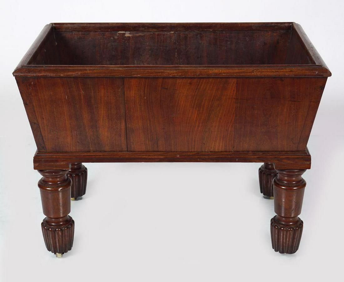 REGENCY MAHOGANY LOG BOX: of sarcophagus form, raised on turned and fluted legs, with inset brass castors. 40 cm. high; 50 cm. wide