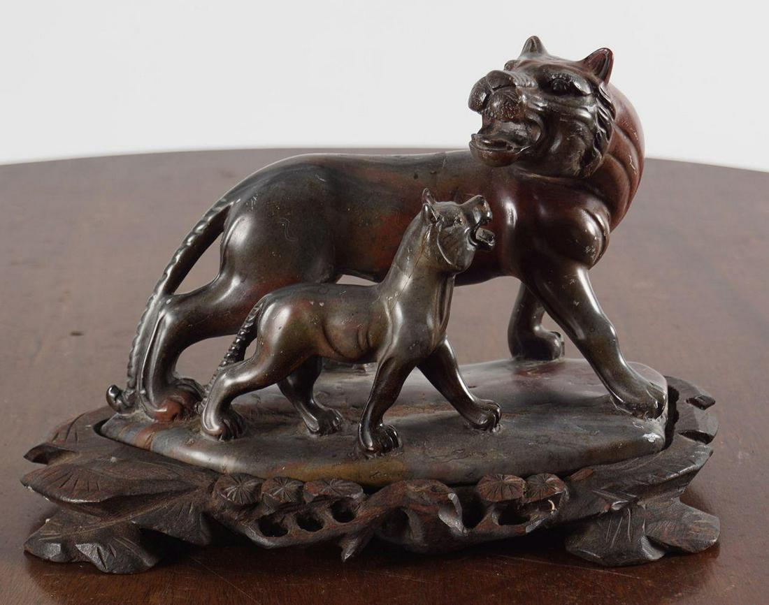 19TH-CENTURY SOAPSTONE SCULPTURE: Lioness and cub, raised on a rocky plateau. 14 cm. high; 20 cm. long