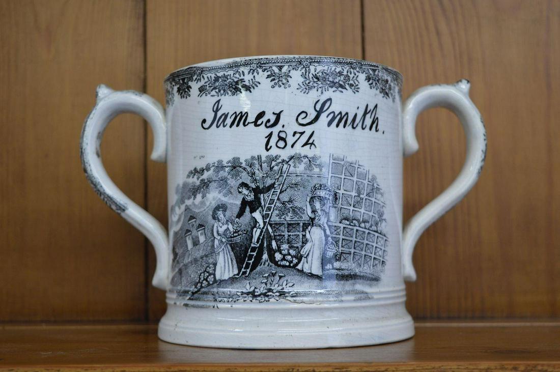 LARGE 19TH-CENTURY TWO-HANDLED MUG: Inscribed James Smith 1874, enclosing a frog. 14 cm. high; 3 cm. wide