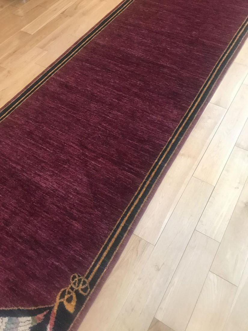 CELTIC PHOENIX PATTERN RUNNER: After a design by William Morris, puce and navy ground with gold borders. 509 x 110 cm.