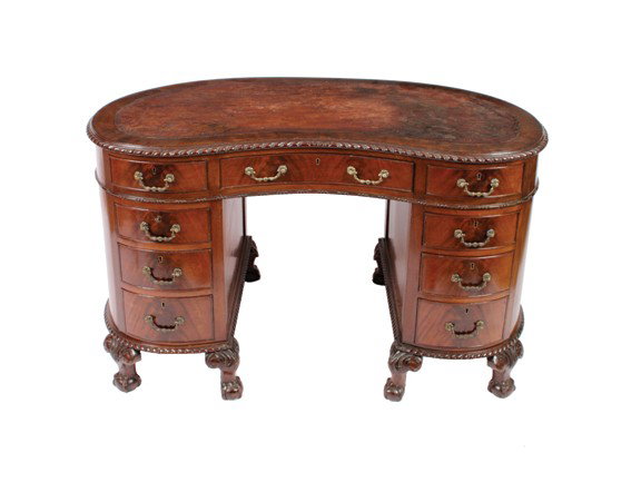 Edwardian mahogany Chippendale style pedestal writ: Edwardian mahogany Chippendale style pedestal writing desk,the kidney shaped tooled leather inset top, above a series of nine conforming drawers, furnished with brass scroll handles, raised on cabriol