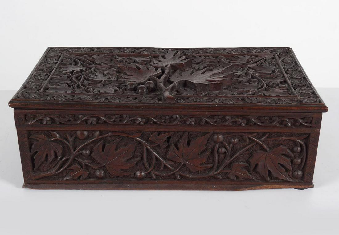 19TH-CENTURY HARDWOOD JEWELLERY BOX: and cover, with profuse all-over leaf decoration.10 cm. high; 34 cm. wide; 20 cm. deep