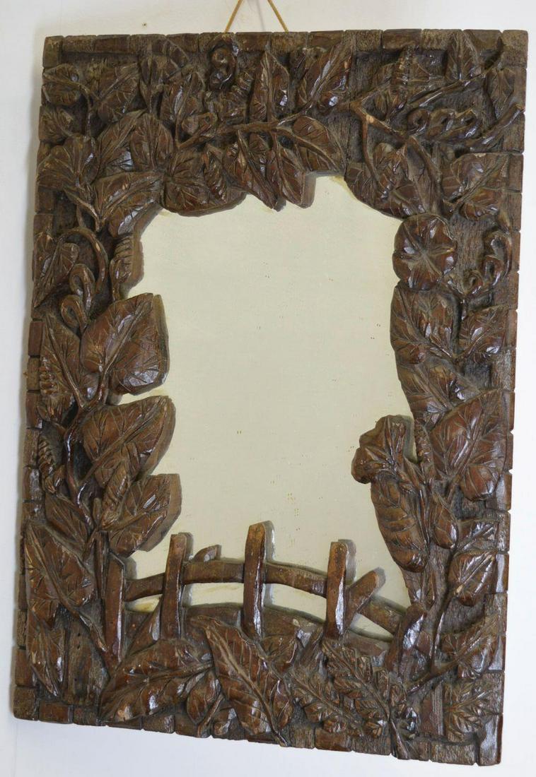 19TH-CENTURY CARVED FRAMED MIRROR: the irregular rectangular plate enclosed in a foliate landscape frame with humpback bridge. 57 x 40 cm. approximate time: 10:39:36