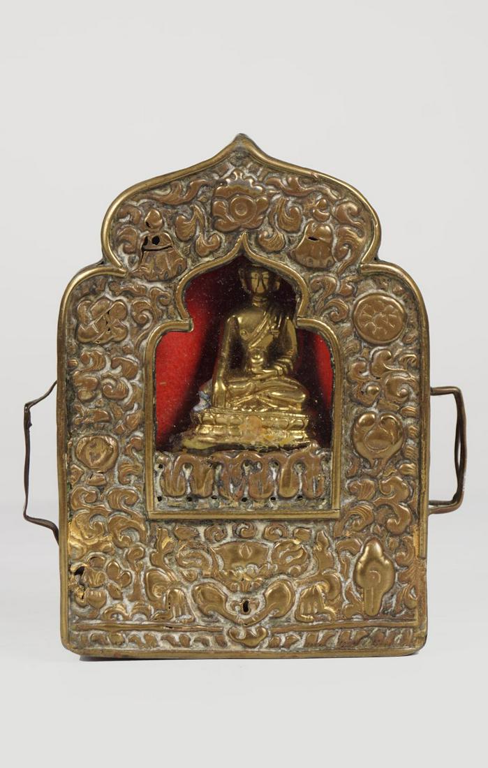 TIBETAN MIXED METAL GAU BOX: with padmasambhava (travel altar box).Provenance: The Collection of the late Dr. Jan Mohamed, Pouldrew House, Co. Waterford. 11 cm. high(Lot 568)