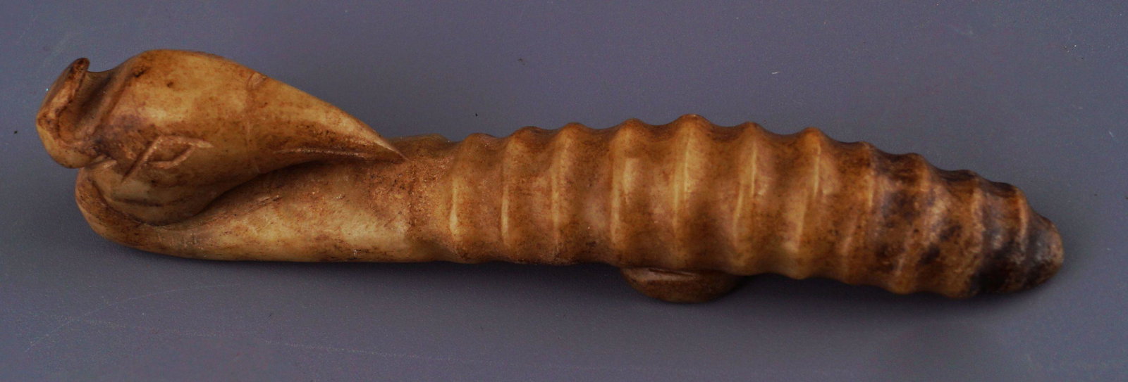 CHINESE ARCHAIC MUTTON FAT JADE BELT HOOK: with phoenix head and tail.Provenance: The Collection of the late Dr. Jan Mohamed, Pouldrew House, Co. Waterford. 10 cm. long (Lot 1540)