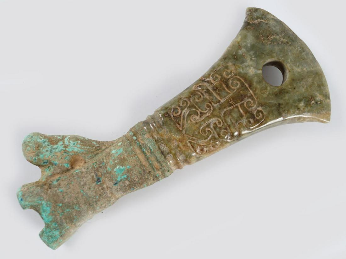 CHINESE ARCHAIC JADE CEREMONIAL AXE: with bronze handle and taotie mask decoration.Provenance: The Collection of the late Dr. Jan Mohamed, Pouldrew House, Co. Waterford. 20 cm. long(Lot 1764)