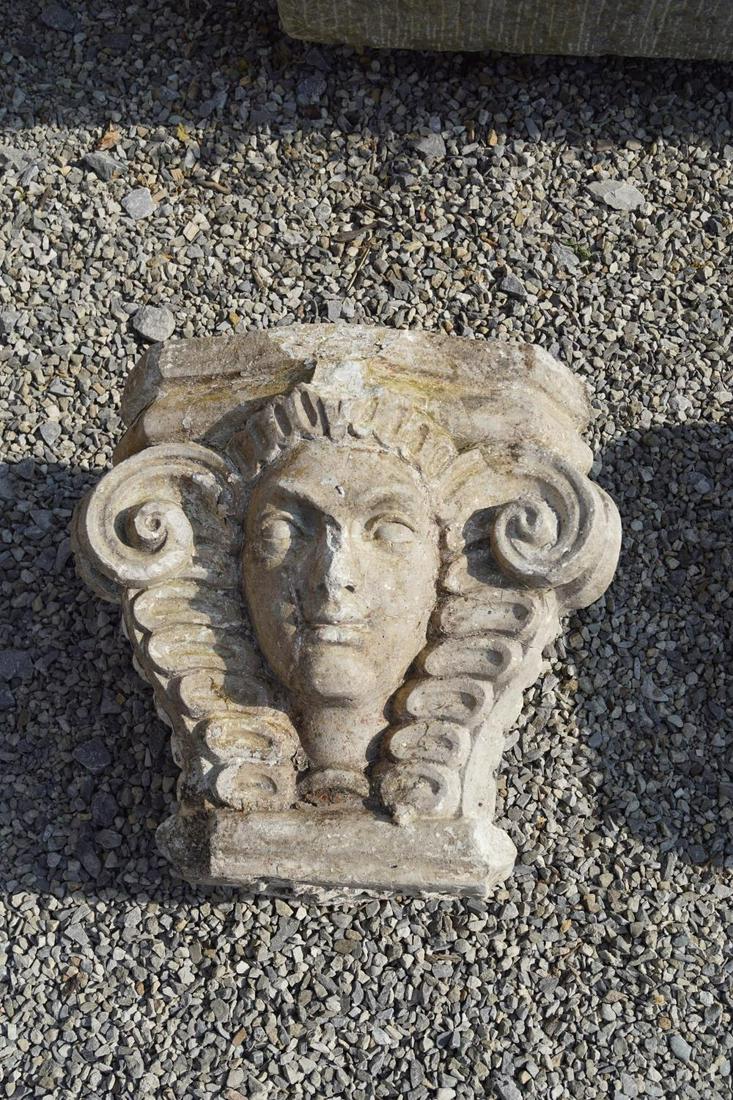 PAIR OF LATE 18TH-CENTURY COMPOSITE STONE CAPITALS: each with a sphinx mask between scroll volutes. 44 cm. high; 43 cm. wide Approximate Time: 10:05 Lot No: 7 Category: Garden & Decorative Objects