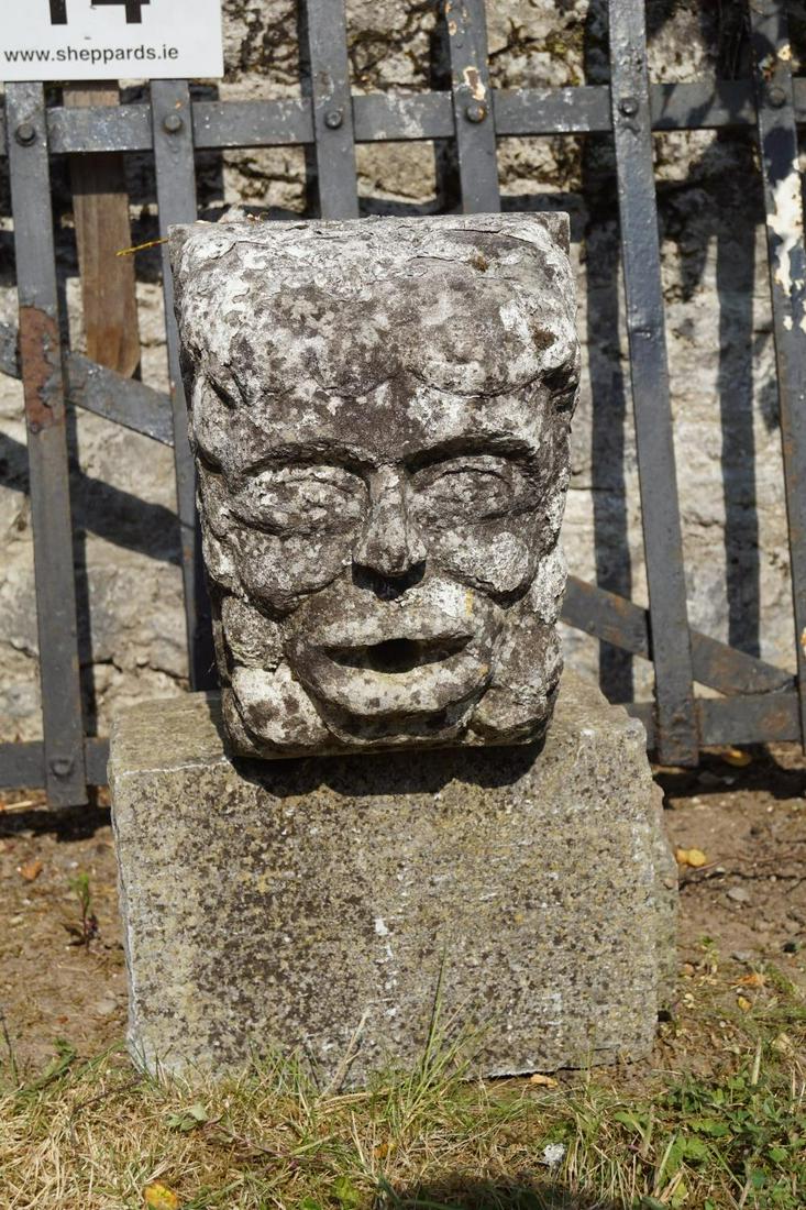 17TH-CENTURY CARVED STONE MASK: of square form. 30 cm. high; 33 cm. wide Approximate Time: 10:12 Lot No: 15 Category: Garden & Decorative Objects