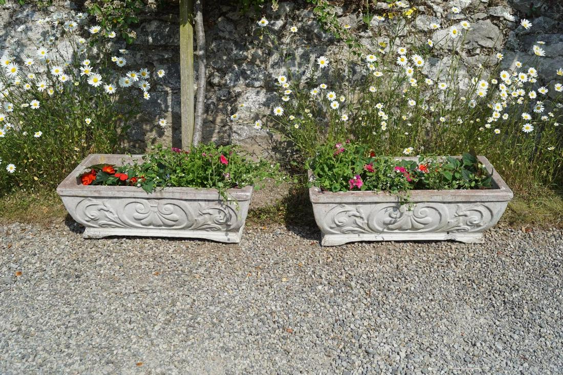 PAIR OF COMPOSITE STONE PLANTERS: with armorial decoration. 26 cm. high; 74 cm. wide; 35 cm. deep; Approximate Time: 10:30 Lot No: 35 Category: Garden & Decorative Objects