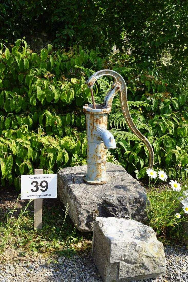 19TH-CENTURY CAST IRON PUMP: mounted on a cut stone plinth. Approximate Time: 10:34 Lot No: 39 Category: Garden & Decorative Objects