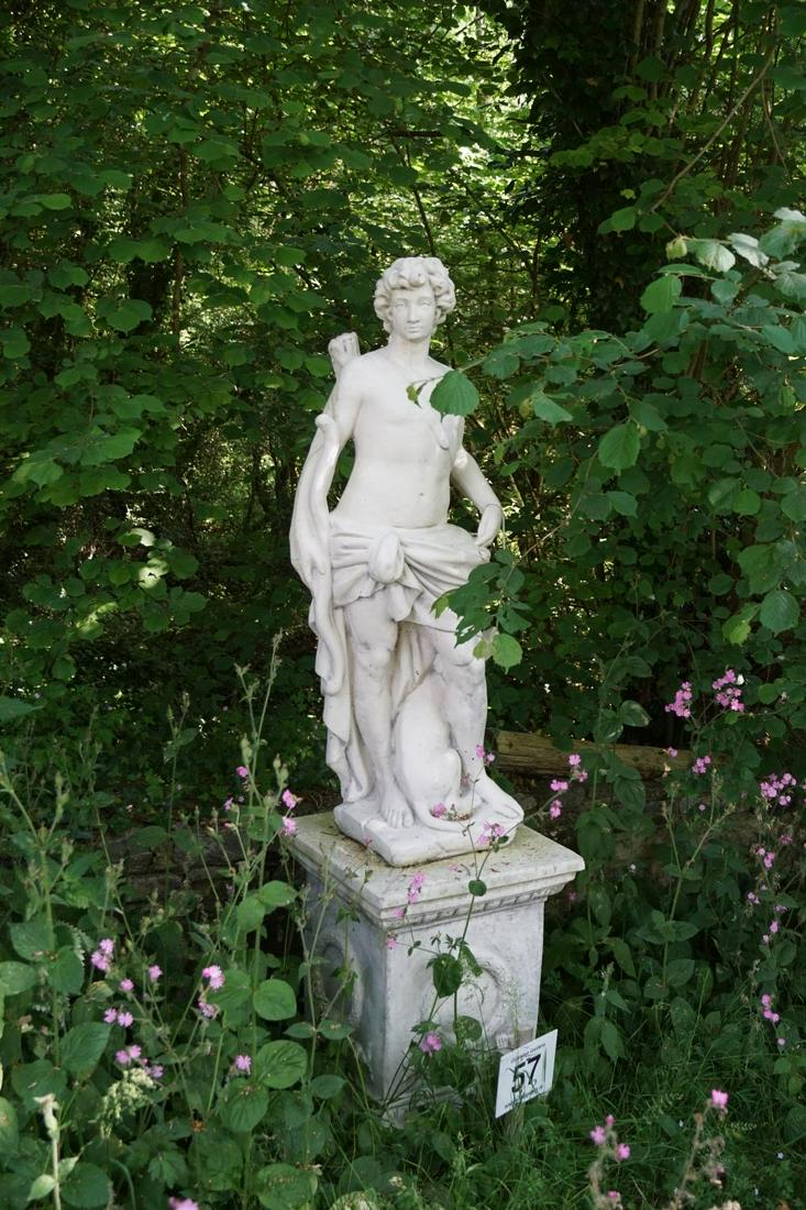 CLASSICAL MOULDED STONE SCULPTURE: Apollo, raised on a moulded square plinth, centred by a laureate wreath. 214 cm. high; Approximate Time: 10:50 Lot No: 57 Category: Garden & Decorative Objects