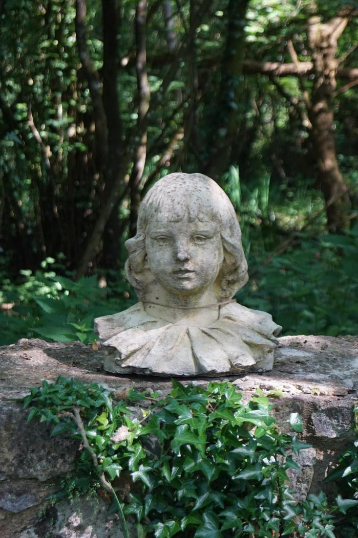 MOULDED STONE HEAD: of a young girl. 32 cm. high; 34 cm. wide Approximate Time: 10:56 Lot No: 64 Category: Garden & Decorative Objects