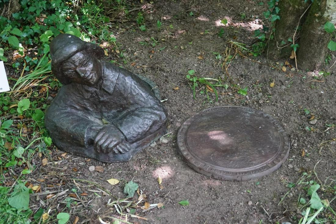 INTERESTING BRONZE GARDEN SCULPTURE: depicting a work man coming out of a manhole. 60 cm. high; 60 cm. wide Approximate Time: 11:04 Lot No: 73 Category: Garden & Decorative Objects