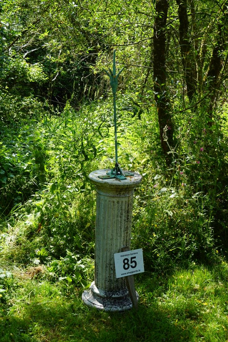 BRONZE GARDEN SCULPTURE: mounted on a moulded stone column, with fluted stem. Overall height: 164 cm. high Approximate Time: 11:15 Lot No: 85 Category: Garden & Decorative Objects