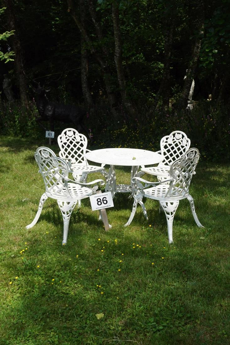 HEAVY CAST IRON PATIO SUITE: Comprising 4 armchairs, and a circular table, raised on cabriole legs. Table: 84 cm. diameter Approximate Time: 11:16 Lot No: 86 Category: Garden & Decorative Objects