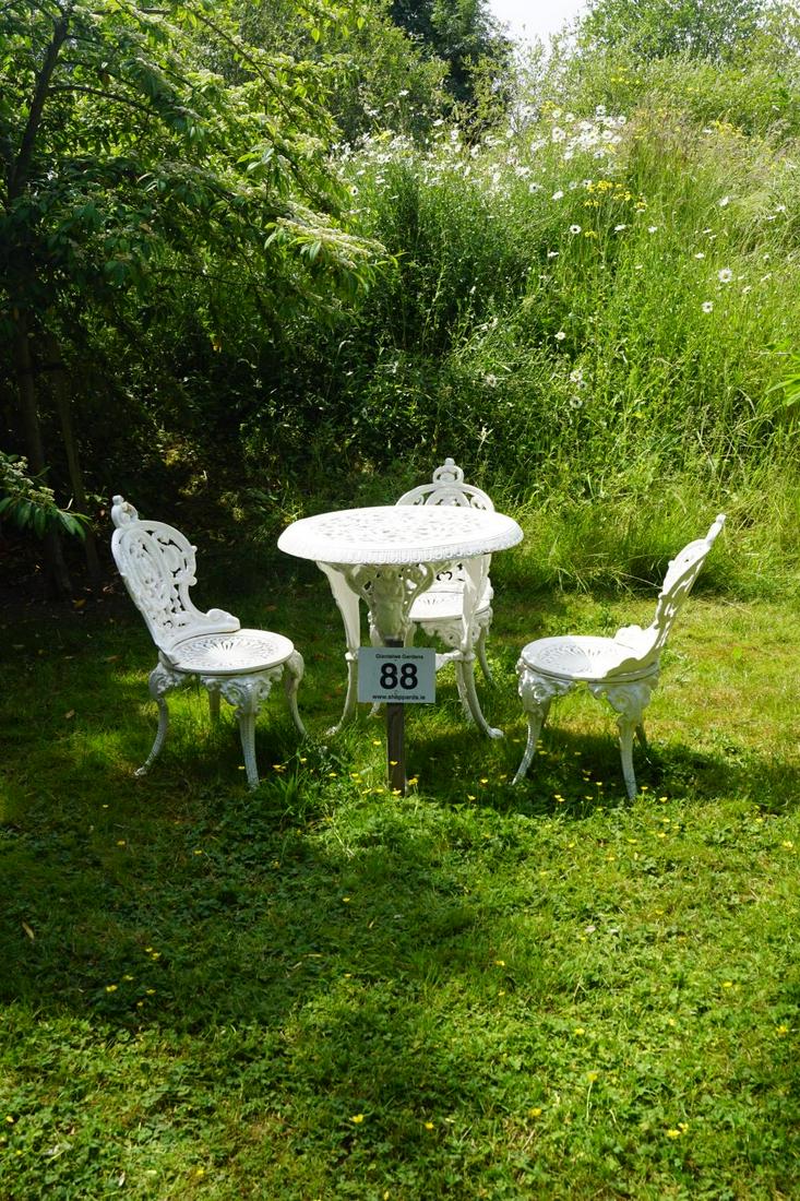 ORNATE CAST IRON PATIO SUITE: Comprising: a circular table and four matching chairs. Approximate Time: 11:18 Lot No: 88 Category: Garden & Decorative Objects
