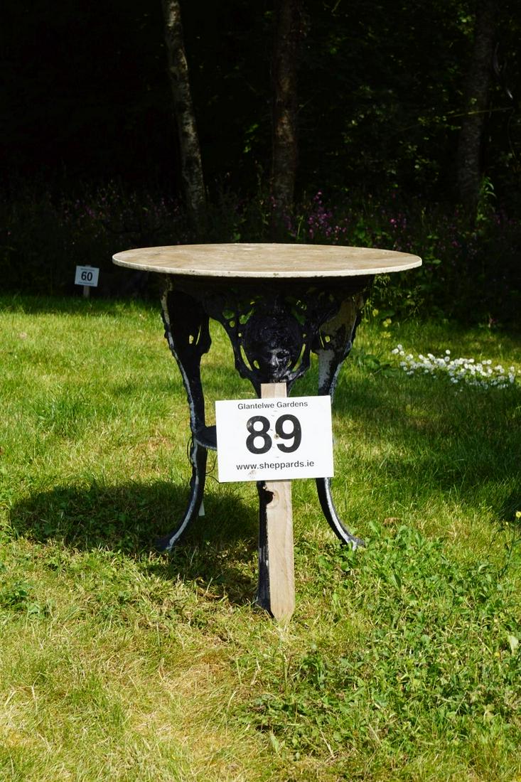 PAIR CAST METAL GARDEN TABLES: each with a circular top, above Anna Livia mask decorated cabriole legs. 67 cm. high; 60 cm. in diameter; Approximate Time: 11:19 Lot No: 89 Category: Garden & Decorative Objects