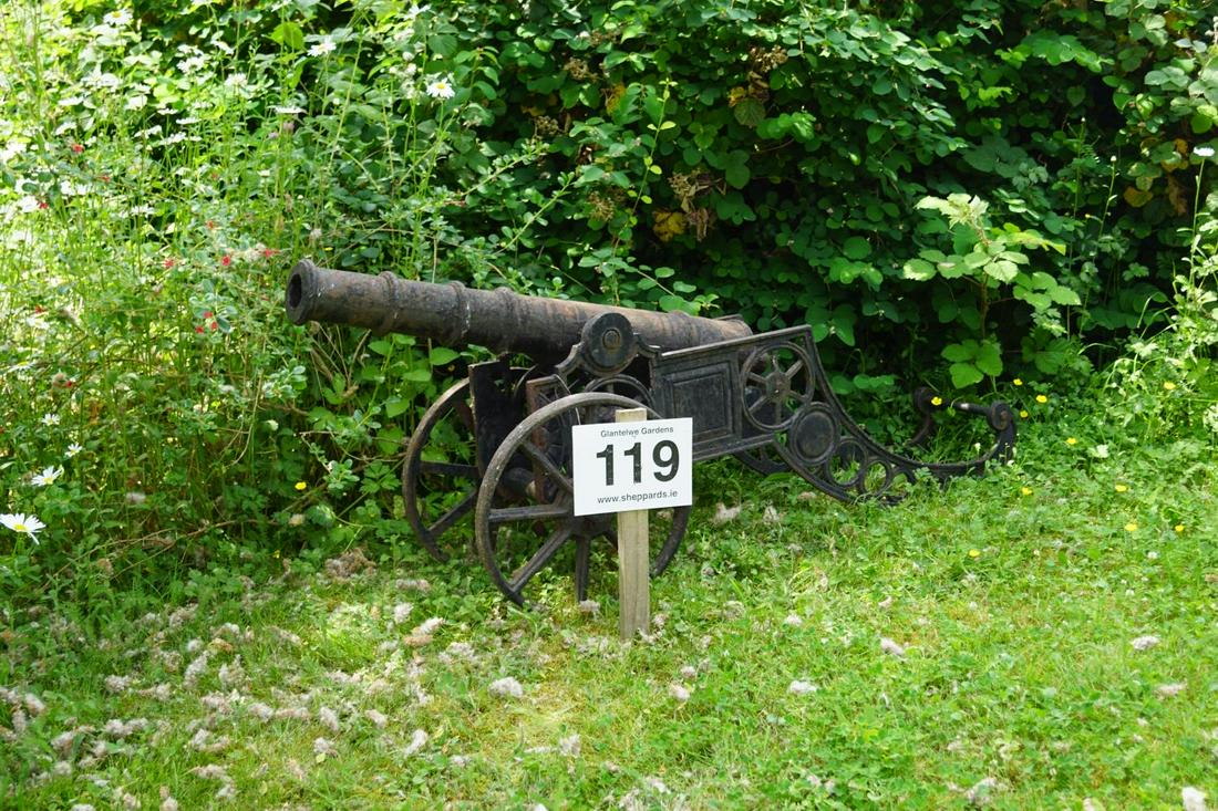 CAST IRON CANNON: mounted on a twin-wheeled carriage. 70 cm. high; 160 cm. long Approximate Time: 11:46 Lot No: 119 Category: Garden & Decorative Objects