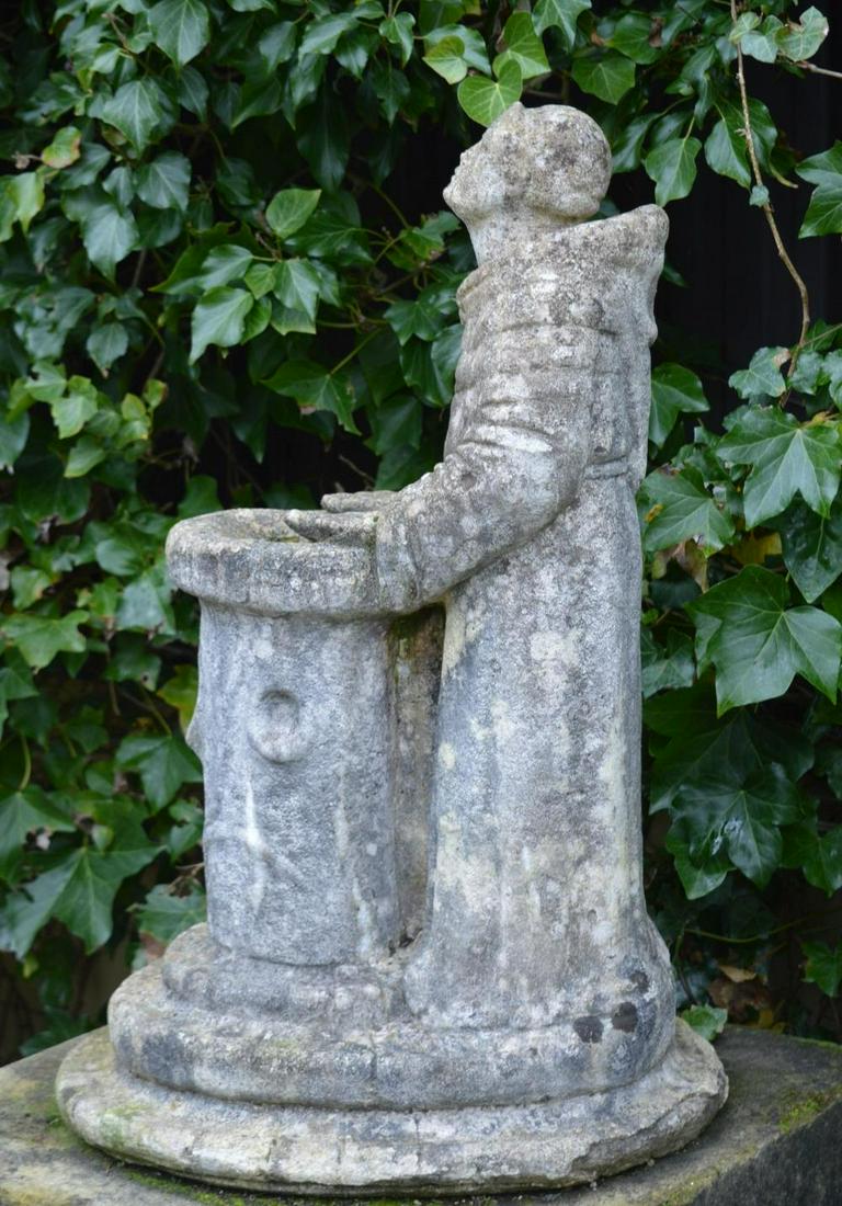 COMPOSITE STONE SCULPTURE GROUP: Figure of St. Francis standing beside a birdbath. 75 cm. high; 50 cm. wide Approximate Time: 11:48 Lot No: 122 Category: Garden & Decorative Objects