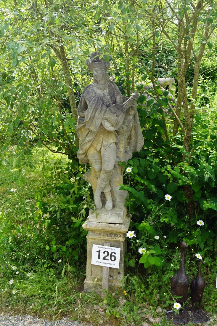 LARGE MOULDED STONE GARDEN SCULPTURE: Figure of a minstrel standing beside a tree stump. 185 cm. high; Approximate Time: 11:52 Lot No: 126 Category: Garden & Decorative Objects