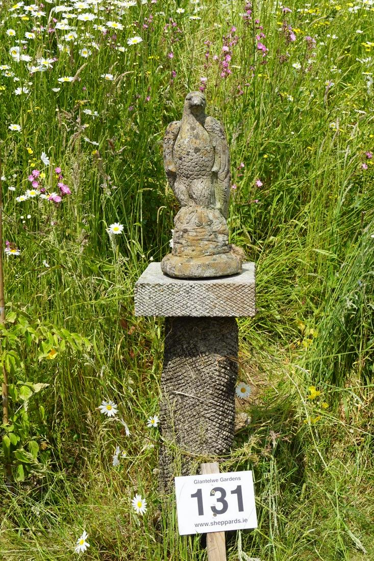 MOULDED STONE GARDEN SCULPTURE: Figure of an eagle mounted on a cut stone pillar. Approximate Time: 11:57 Lot No: 131 Category: Garden & Decorative Objects