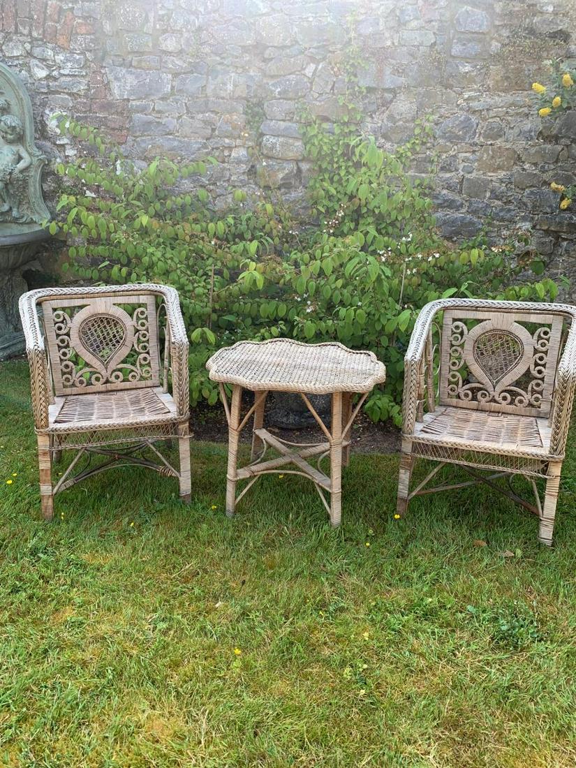 CONSERVATORY WICKER WORK TABLE: and two chairs. Chairs: 80 cm. high; 60 cm. wide; 50 cm. deep; table: 60 cm. high; 66 cm. wide; 58 cm. deep Approximate Time: 12:01 Lot No: 136 Category: Garden & Decorative Objects