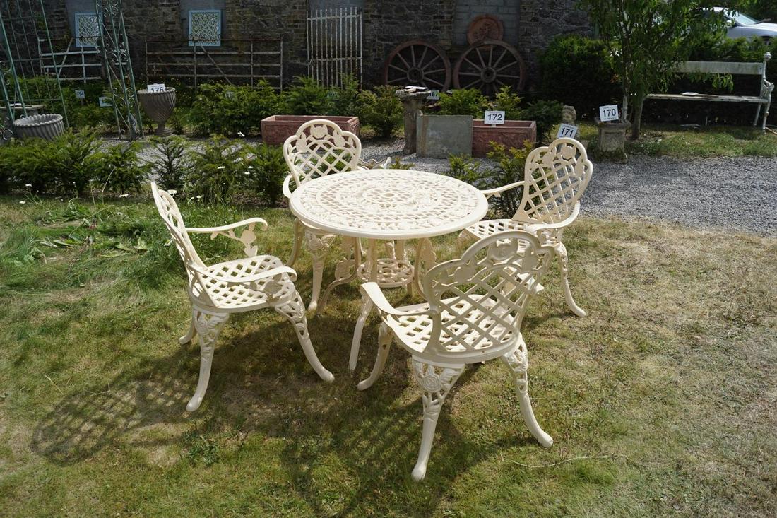 CAST IRON PATIO TABLE: and 4 armchairs. 70 cm. high; Table: 90 cm. diameter Approximate Time: 12:28 Lot No: 166 Category: Garden & Decorative Objects