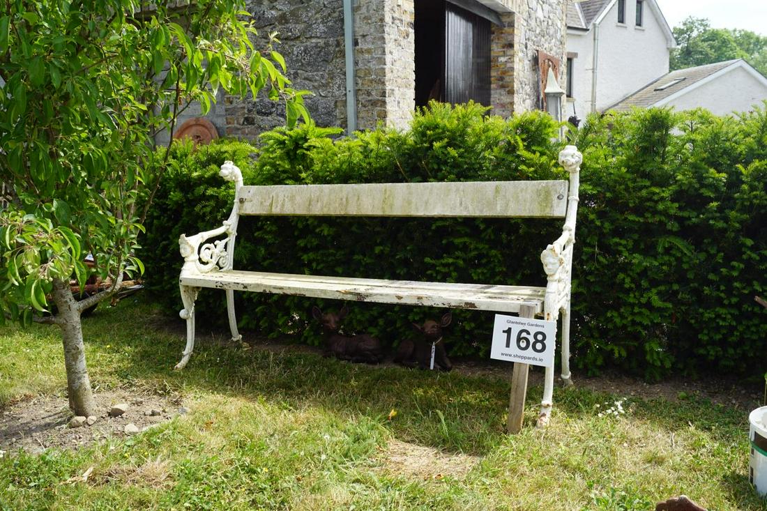 IRON GARDEN BENCH: with wood back and seat, supported on figure headed scroll ends. Approximate Time: 12:30 Lot No: 168 Category: Garden & Decorative Objects