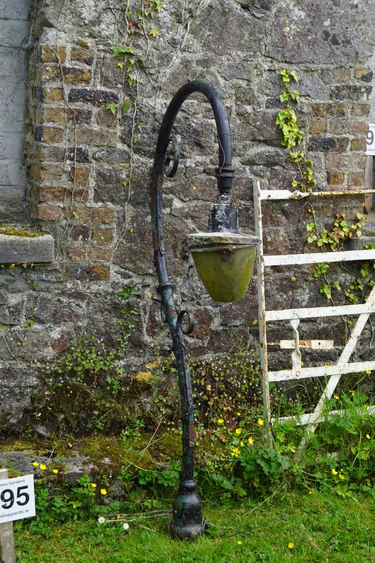 CAST IRON GARDEN LIGHT: of scroll form. 171 cm. high; 78 cm. wide Approximate Time: 12:54 Lot No: 195 Category: Garden & Decorative Objects