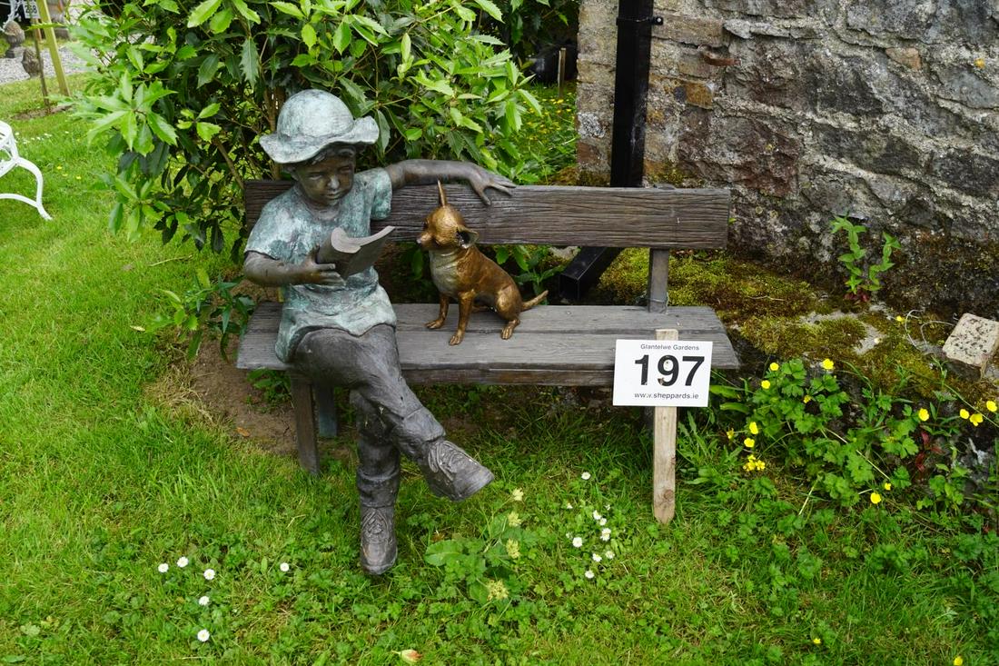 BRONZE GARDEN INSTALLATION: Young boy and a puppy on a bench. 100 cm. high; 120 cm. wide; Approximate Time: 12:56 Lot No: 197 Category: Garden & Decorative Objects