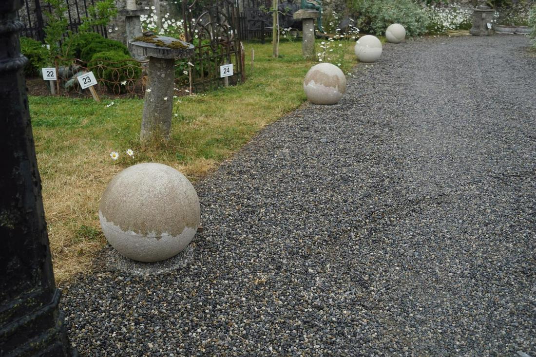 GROUP OF FOUR MOULDED GRANITE EDGING SPHERES: Group of four moulded granite edging spheres. 60 cm. in diameter; Approximate Time: 14:26 Lot No: 230 Category: Garden & Decorative Objects