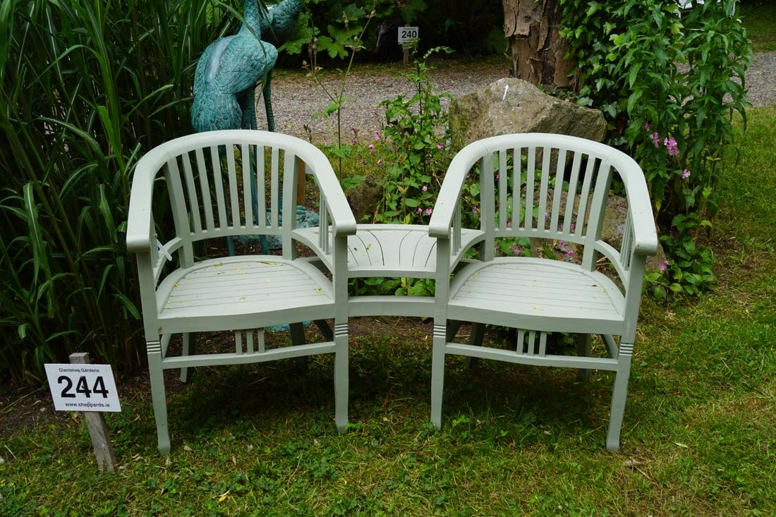 PAINTED HARDWOOD GARDEN BENCH: with integrated table. 88 cm. high; 153 cm. wide; Approximate Time: 14:38 Lot No: 244 Category: Garden & Decorative Objects