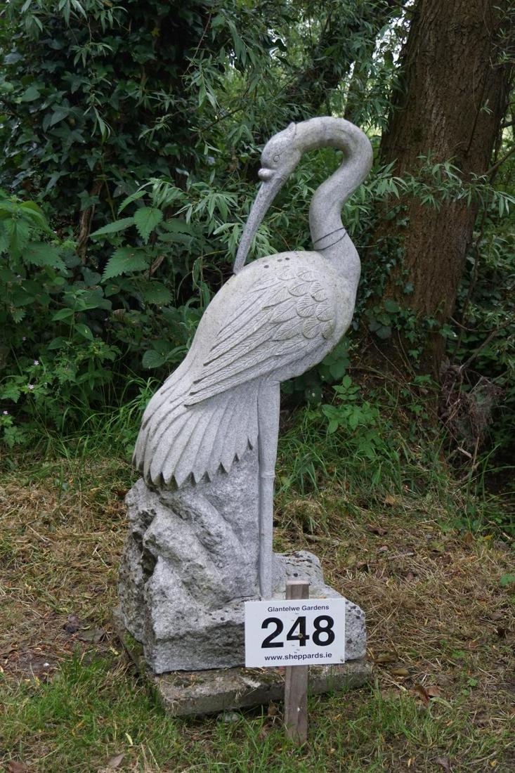 LARGE CARVED GRANITE GARDEN SCULPTURE: Figure of a crane standing on a rocky mound. 125 cm. high; Approximate Time: 14:42 Lot No: 248 Category: Garden & Decorative Objects