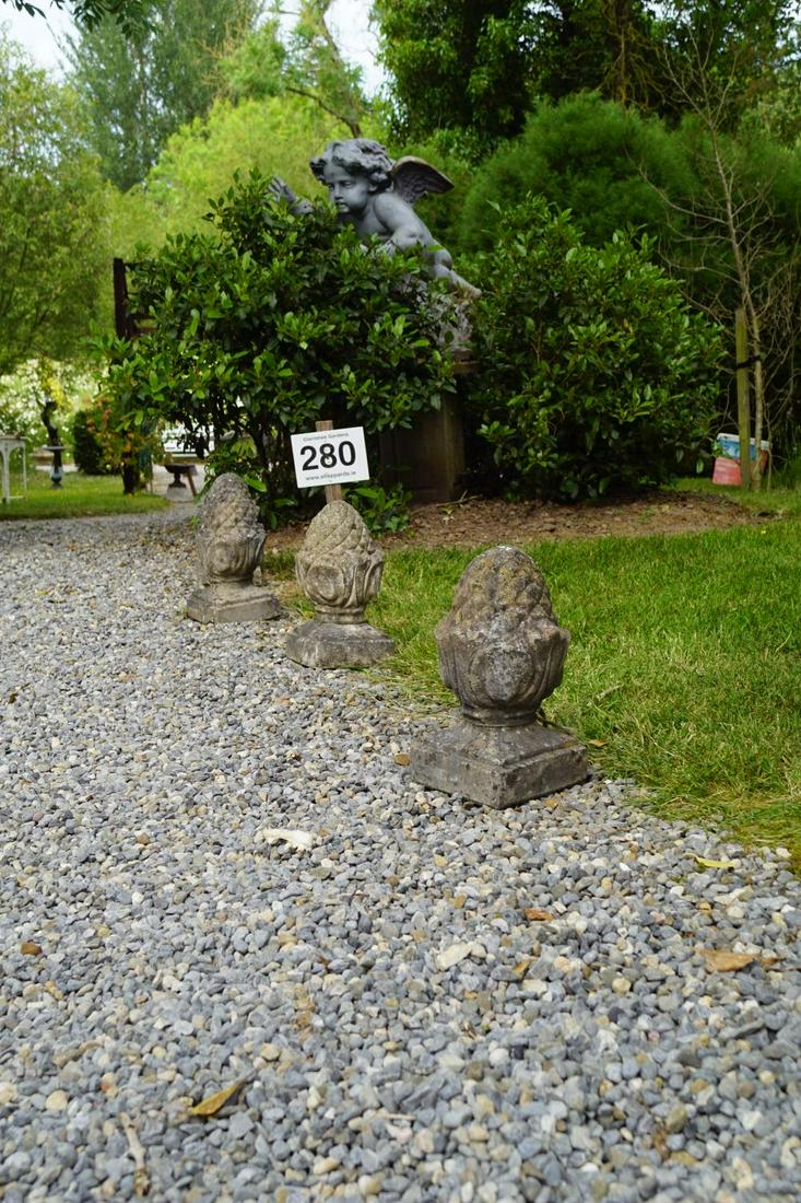 GROUP OF FOUR WEATHERED COMPOSITE STONE ACORNS: each with a square base. 30 cm. high; Approximate Time: 15:11 Lot No: 280 Category: Garden & Decorative Objects