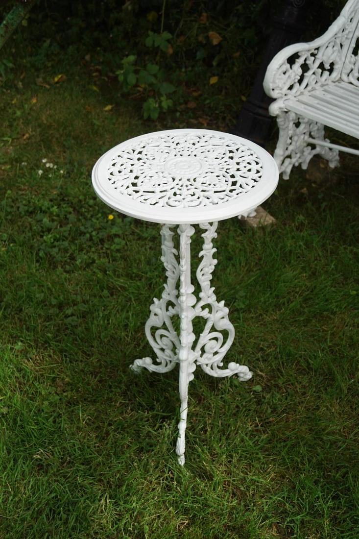 CAST IRON PATIO TABLE: the circular shaped top, raised on scroll supports. 71 cm. high; 36 cm. wide Approximate Time: 15:20 Lot No: 290 Category: Garden & Decorative Objects