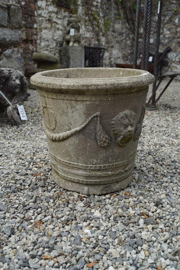 ITALIANATE STONE GARDEN URN: of circular tapered form with raised moulded mask and swag decoration. 40 cm. high; 40 cm. in diameter; Approximate Time: 15:42 Lot No: 315 Category: Garden & Decorative Objects