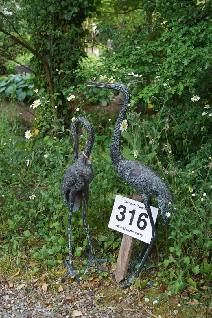 PAIR OF BRONZED METAL GARDEN SCULPTURES: each a standing crane. 85 cm. high; 40 cm. wide Approximate Time: 15:43 Lot No: 316 Category: Garden & Decorative Objects