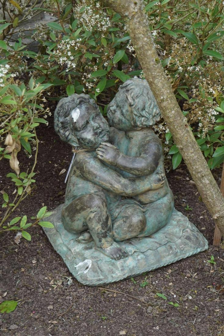 BRONZE GARDEN SCULPTURE: of putti seated on a cushion. 51 cm. high; 40 cm. wide; 40 cm. deep Approximate Time: 16:00 Lot No: 335 Category: Garden & Decorative Objects