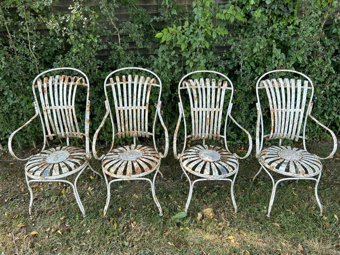 SET OF 4 FRANCOIS CARRE CHAIRS: each with a raised back and seat, between scroll arms. 107 cm. high; 66 cm. wide; 55 cm. deep; Approximate Time: 16:19 Lot No: 356 Category: Garden & Decorative Objects
