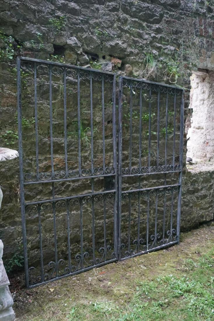 PAIR OF WROUGHT IRON GARDEN GATES: each with scroll openwork and railed panels. 240 cm. high; 144 cm. wide; Approximate Time: 16:46 Lot No: 386 Category: Garden & Decorative Objects