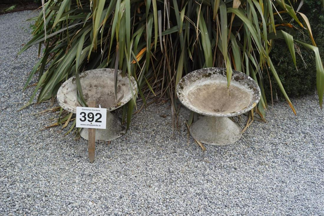 PAIR MID-CENTURY WEATHERED COMPOSITE GARDEN URNS: of tilted circular form, raised on a circular pedestal. 37 cm. high; 62 cm. in diameter; Approximate Time: 16:51 Lot No: 392 Category: Garden & Decorative Objects