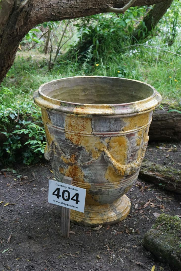LARGE GLAZED TERRACOTTA ANDUZE POT: of vase shape, with moulded floral swag decoration, raised on a circular foot. 77 cm. high; 74 cm. diameter Approximate Time: 10:02 Lot No: 404 Category: Garden & Decorative Objects