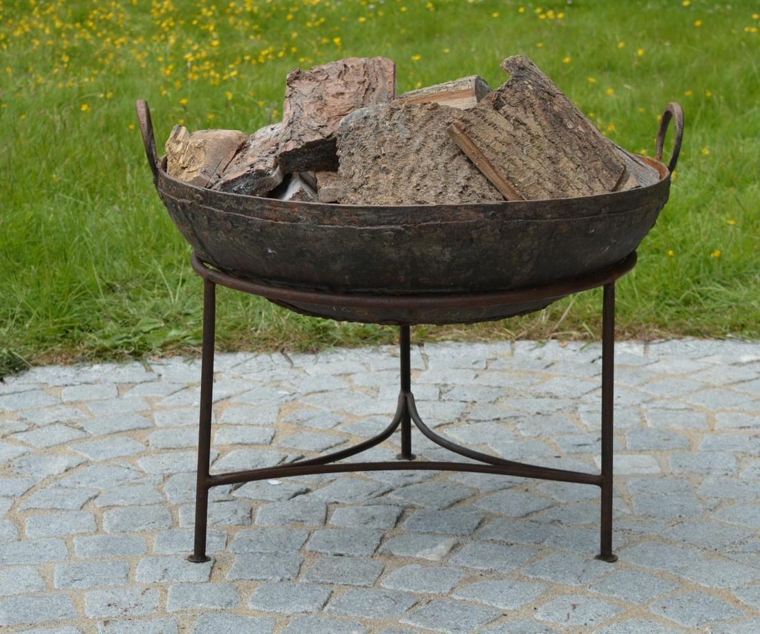 CAST IRON FIRE PIT: of circular form, with lug handles, raised on tripod supports. 60 cm. high; 120 cm. wide Approximate Time: 10:37 Lot No: 443 Category: Garden & Decorative Objects