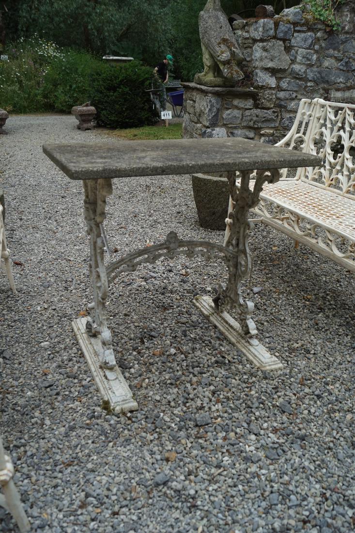 ANTIQUE CAST IRON GARDEN TABLE: with a rectangular composite stone top. 70 cm. high; 76 cm. wide; 50 cm. deep Approximate Time: 10:47 Lot No: 454 Category: Garden & Decorative Objects