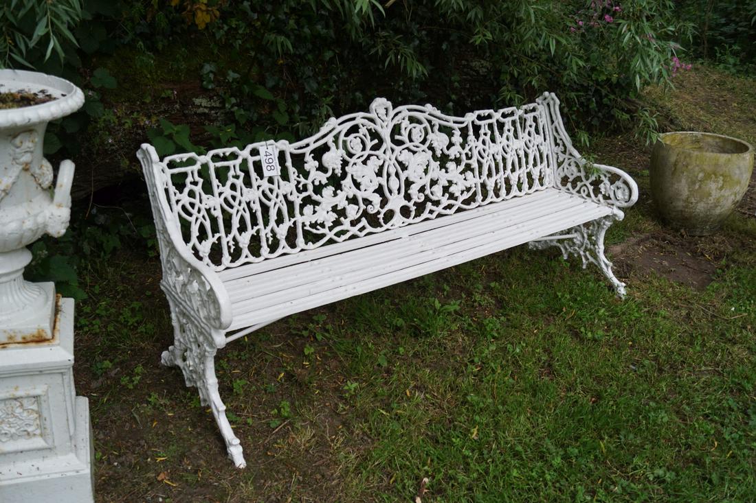 CAST IRON GARDEN BENCH: with intricate leaf decorated panelled back, raised on scroll ends. 83 cm. high; 183 cm. wide; 60 cm. dee Approximate Time: 11:27 Lot No: 498 Category: Garden & Decorative Objects