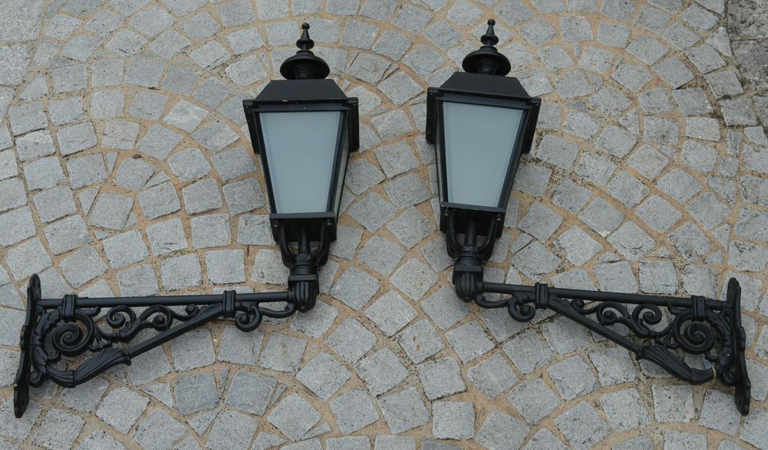 PAIR OF METAL GARDEN LIGHTS: each supported on a cast iron arm. Approximate Time: 11:51 Lot No: 525 Category: Garden & Decorative Objects