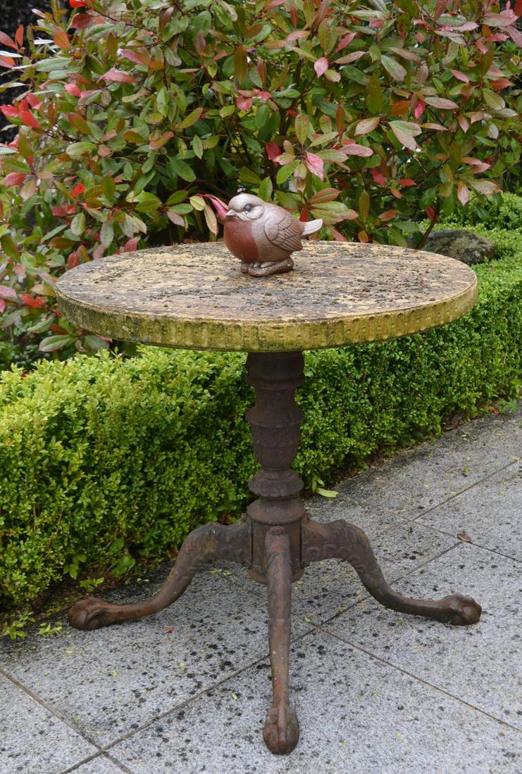 19TH-CENTURY STONE & CAST IRON PATIO TABLE: the circular-shaped top raised on cast iron pod base. 80 cm. high; 86 cm. in diameter; Approximate Time: 11:53 Lot No: 527 Category: Garden & Decorative Objects