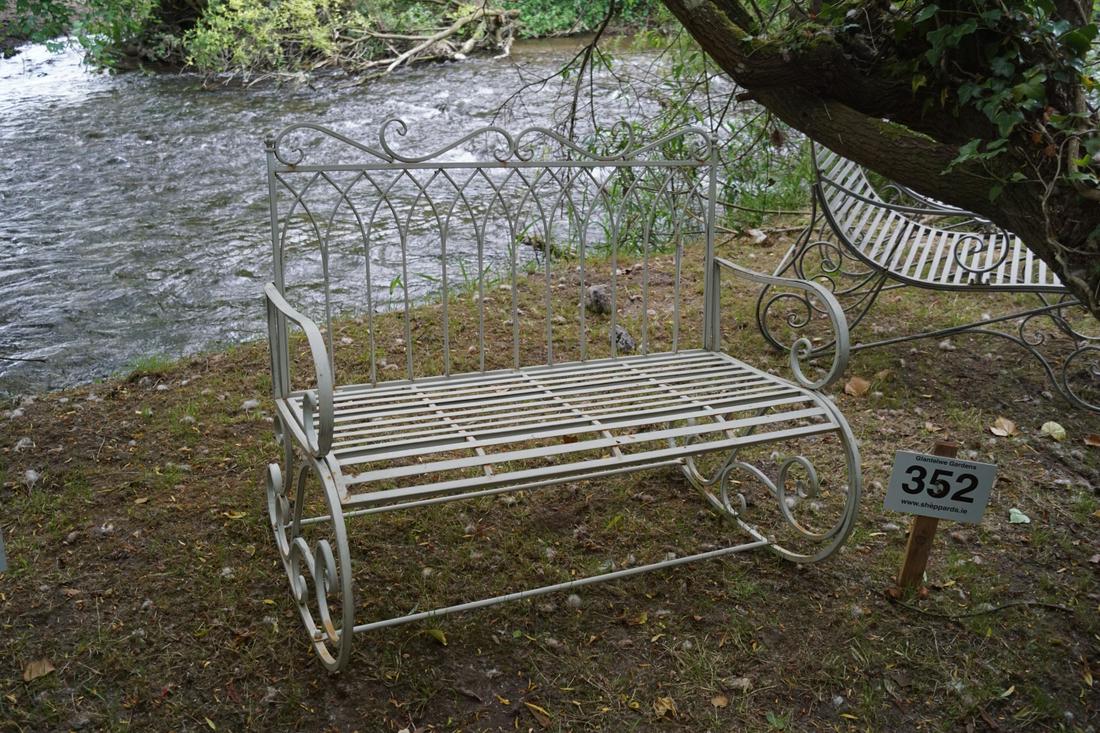 PAINTED METAL GARDEN BENCH: with a Gothic arched panelled back, raised on scroll ends. 93 cm. high; 112 cm. wide; Approximate Time: 11:54 Lot No: 528 Category: Garden & Decorative Objects