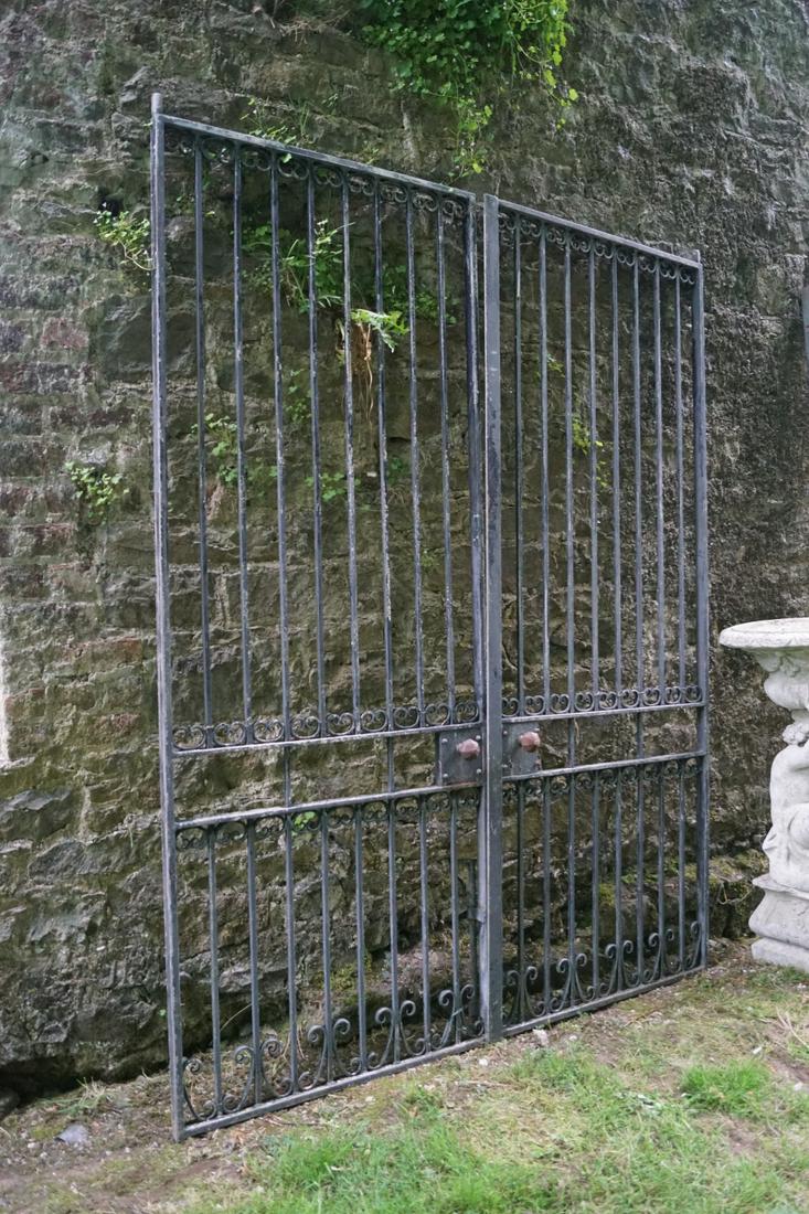 PAIR OF WROUGHT IRON GARDEN GATES: each with scroll openwork and railed panels. 242 cm. high; 184 cm. wide; Approximate Time: 11:57 Lot No: 531 Category: Garden & Decorative Objects